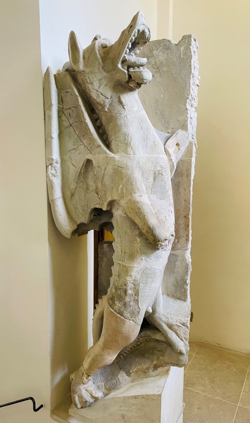 A stone dragon standing upright with mouth open