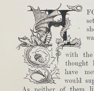 a dragon entwined around the initial A